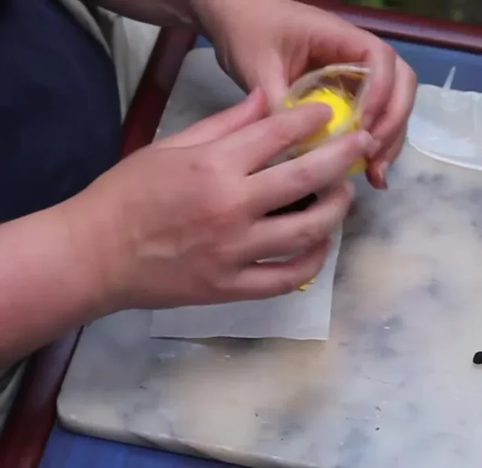 Prepare the yellow clay by rolling it into a small sausage, then cut it in half.