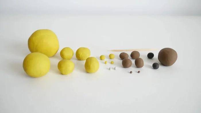 Prepare clay balls of yellow, brown, black, and white.