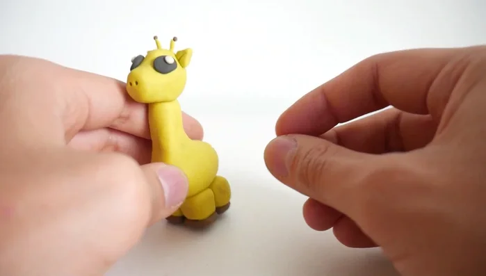 Add spots using small brown clay balls all over the body.