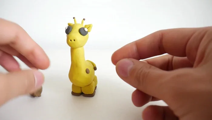 Add spots using small brown clay balls all over the body.