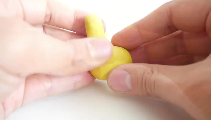 Attach brown clay hooves to the bottom of each leg.