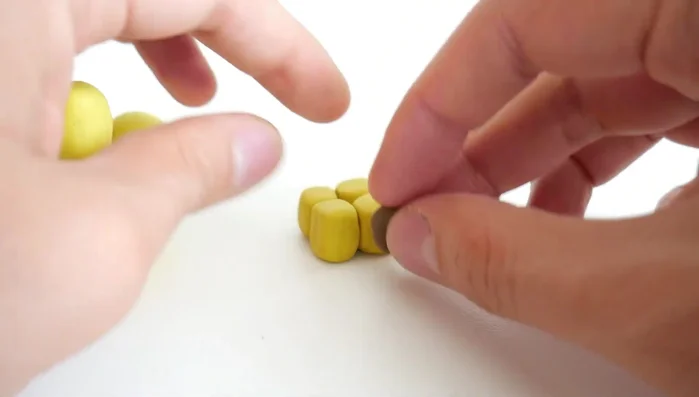 Attach brown clay hooves to the bottom of each leg.