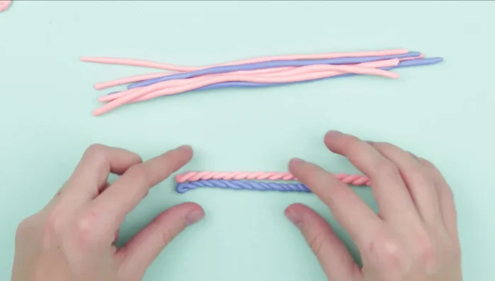 Arrange the twisted rolls on the mitten stencil to resemble a knitting pattern.