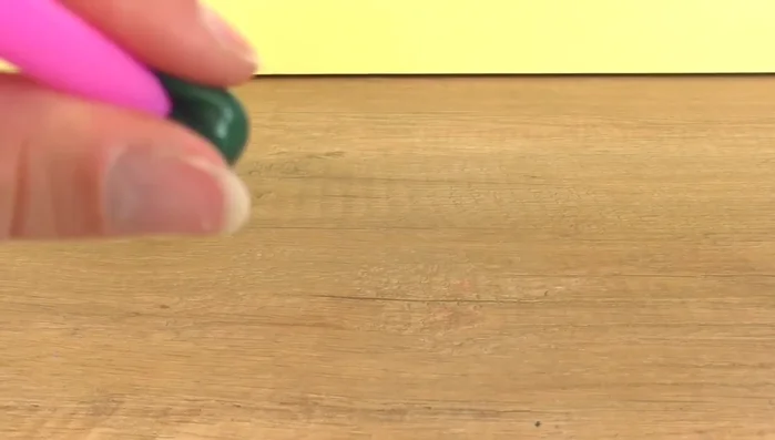 Blow gently through the straw to inflate the material.