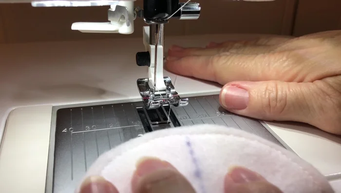 Sew a straight stitch from the initial seam, towards the marked center, stopping ¼ inch from the bottom edge.