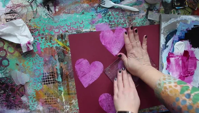 Completely cover the paper with stamped designs using different stamp sizes and shapes.