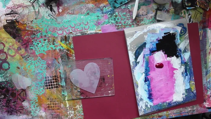 Mix acrylic paints (e.g., pink and white) to achieve your desired color. Apply the paint onto the stamp using a brayer.