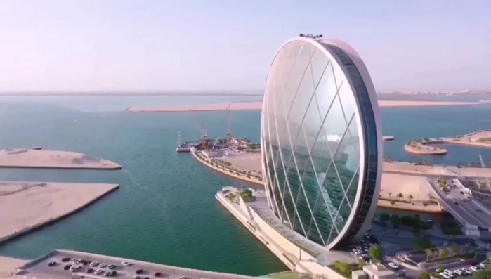 Aldar Headquarters, Abu Dhabi: A disc-shaped glass and steel building with historical symbolism, representing eternity, unity, and stability.