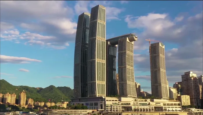 The Shard, London: A tall skyscraper with angled glass facades reflecting sunlight, creating a changing appearance.