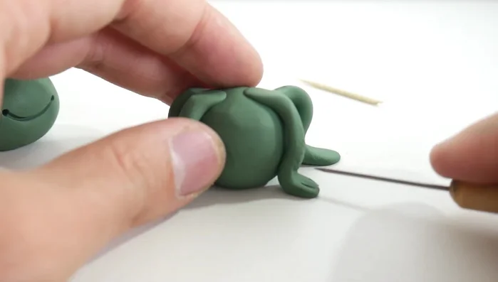 Add toes: Use a pointed tool to create toes on each foot. [231]