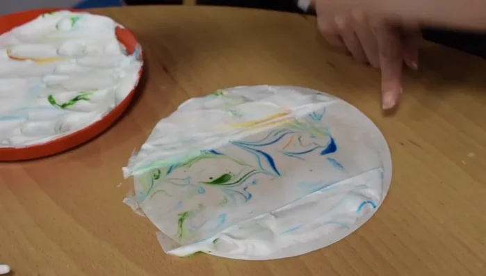 Use a card to scrape off the excess foam.