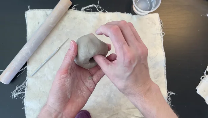Smooth the clay: Use a wet finger to smooth out any rough areas on the clay.