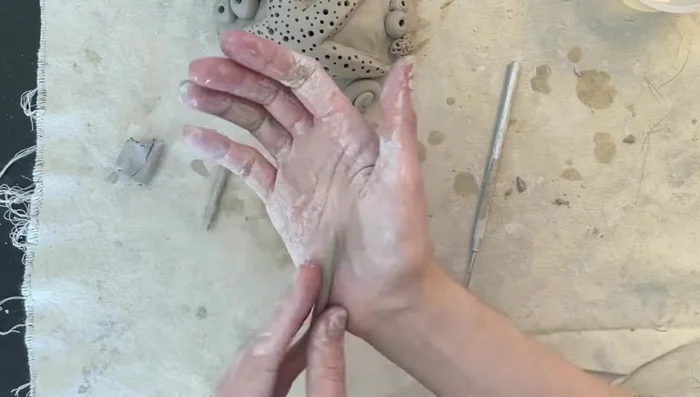 Add seagrass: Roll super thin clay snakes and flatten, using the needle tool to slice off the bottom for even attachment to the base.