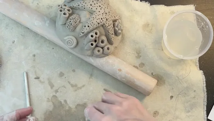 Final Touches: Add a final sea snail and carve your name into the bottom of the wreath.