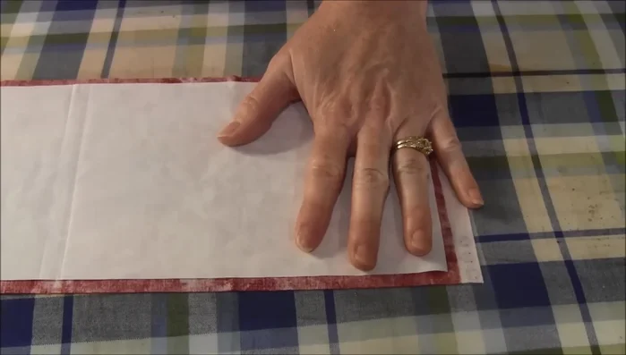 Fuse Fabric Squares: Place the two fabric squares together (right sides out) and fuse them together with an iron.