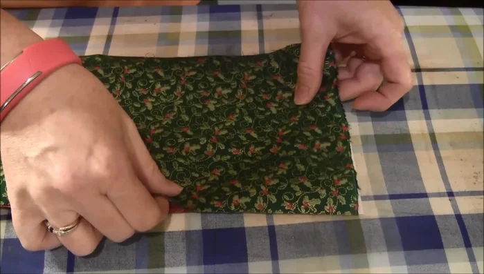 Fuse Fabric Squares: Place the two fabric squares together (right sides out) and fuse them together with an iron.