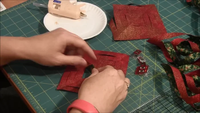 Twist, Glue, and Flip: Start with your dominant fabric facing up. Twist each resulting triangle shape, apply hot glue to the edges, and flip the glued section over. Repeat the process for all sections.