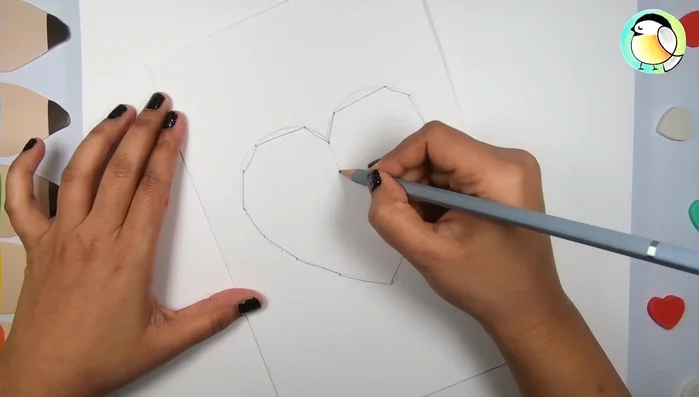 Draw a smaller heart within the larger one, extending two centimeters.