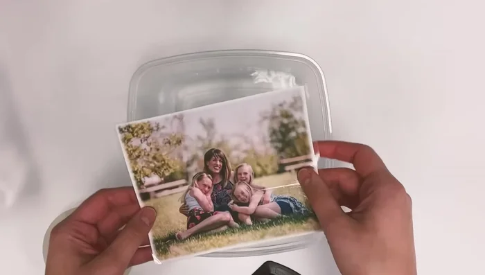 Gently rub off the paper backing with your fingers until only the ink remains.