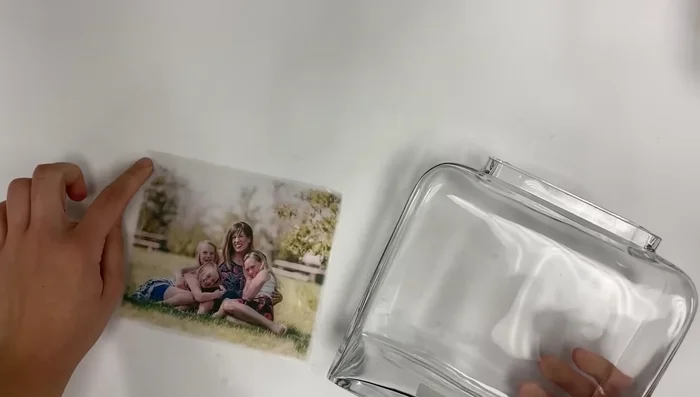 Burnish the back of the photo again to adhere it to the glass.