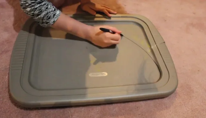 Create the monofin: Cut a fin shape from a plastic storage container lid using a sharp knife. This is the most crucial part of the process.