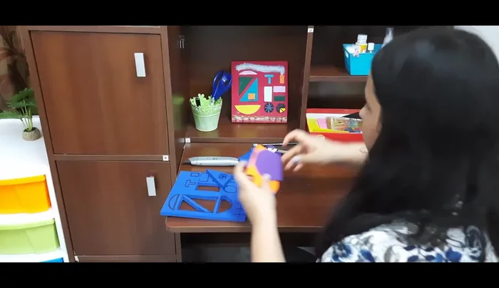 Cut out shapes from the colored foam sheets. These shapes will be glued onto the foam base.
