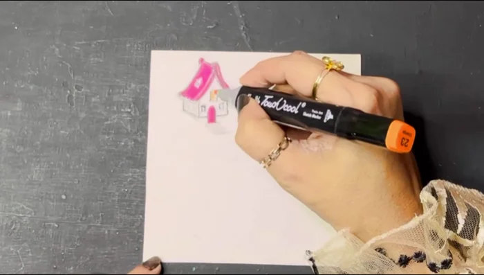 Attach the house cutout inside the plastic bottle.