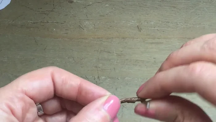 Create the spout using brown paper-covered wire, twisting it to make it thicker, bending it into an S-shape, and pushing it through the spout hole. Secure with glue and extra felt.