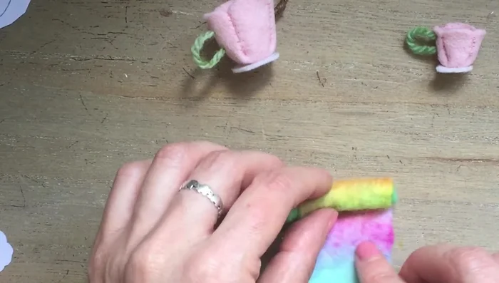 Cut out the oval felt section for the teapot top and glue it on top of the rolled felt.