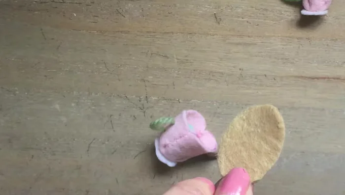 Cut out the oval felt section for the teapot top and glue it on top of the rolled felt.