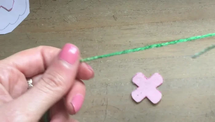 Sew the teacup handle: Start on the inside, pull through, and go back through to the other point. Anchor a tiny bit of felt on the other side and sew another knot to finish.