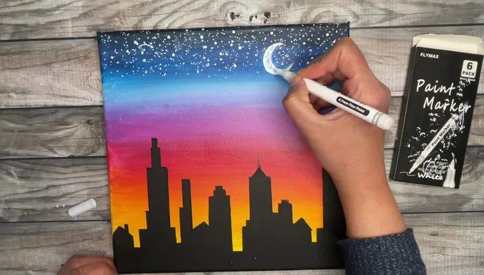 Paint the moon using a fine point paint marker or small round brush. Use a Q-tip to create crater effects.