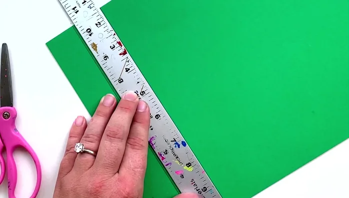 Prepare the paper: Cut four pieces of paper into five equal sections using a ruler.