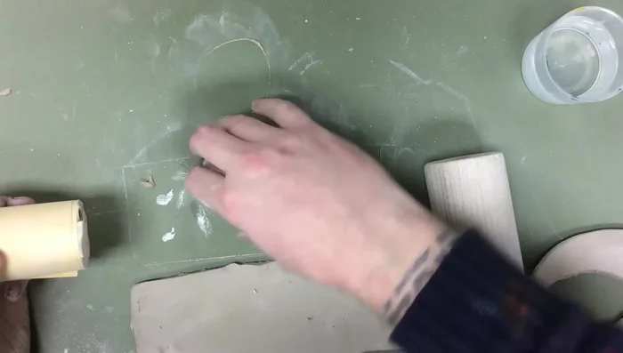 Smooth over the seams and cracks, pushing clay from one piece onto the other to ensure a good connection. Keep the clay wet to help soften it.