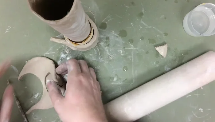 Create a Pac-Man ghost shape and attach it using slip, scratch, and smooth technique.