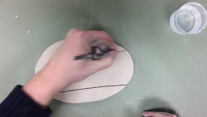 Roll out another small slab for the mug's bottom, using something round as a template if desired.