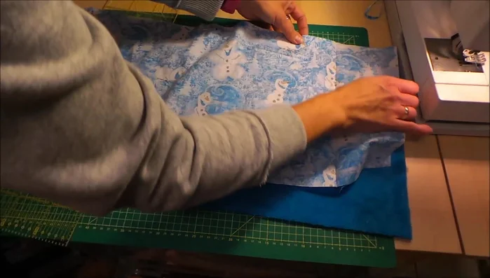 Sew the lengthwise seam: Sew the two fabrics together along the pinned edges using a sewing machine.