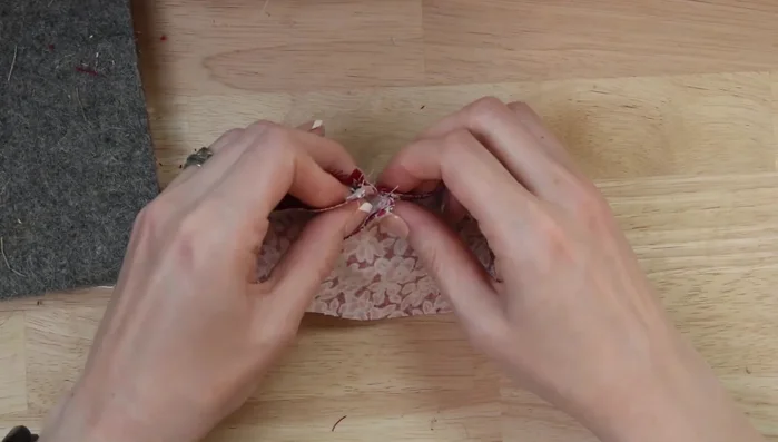 Sew along the top of the cape to secure the hood. Check hood placement before continuing.