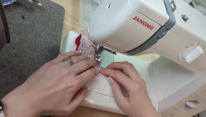 Sew along the top of the cape to secure the hood. Check hood placement before continuing.