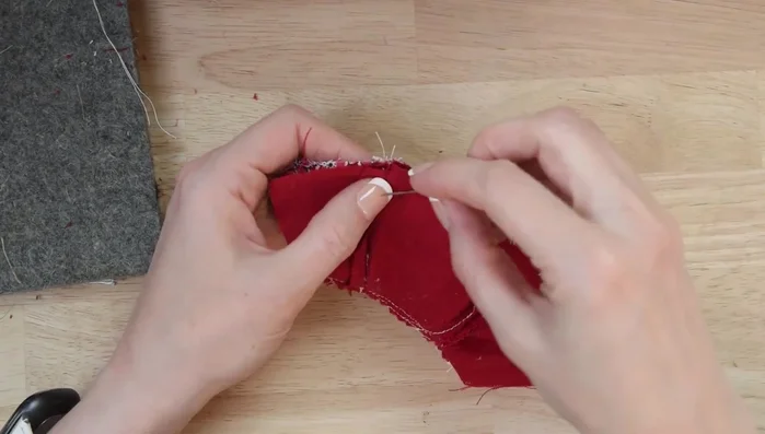 Press the cape, ensuring the bottom opening is neatly folded. Use a hot glue finger guard to avoid burning fingers.