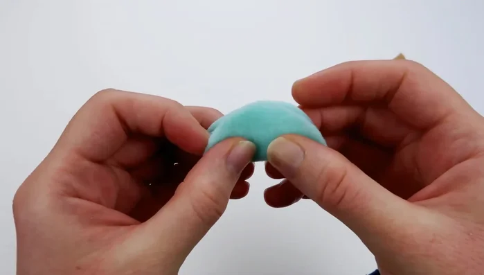 Use a running stitch to sew around the perimeter of the ice cream piece, then pull the thread to gather the fabric into a scoop shape. Fill with stuffing and knot the thread securely.