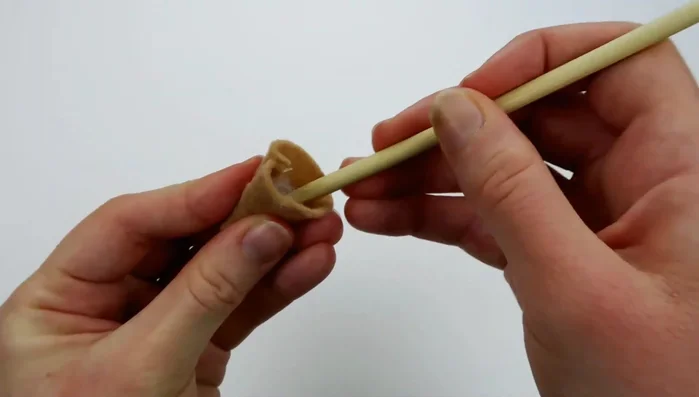 Fill the ice cream cone with stuffing. Place the ice cream scoop on top of the cone and sew them together using a back stitch.