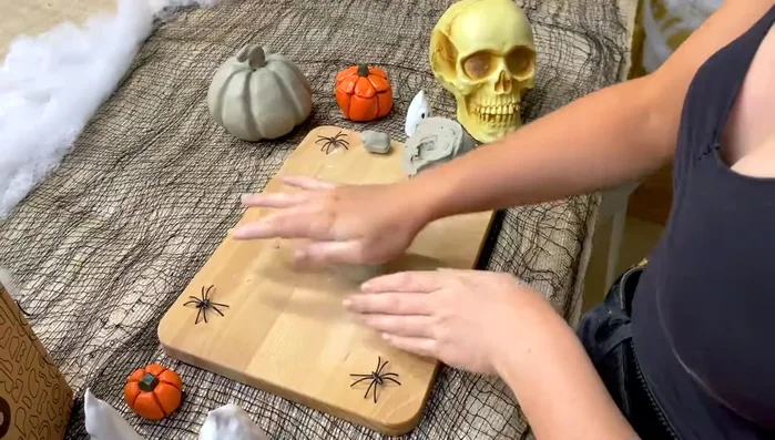 Create two pinch pots: Roll each clay half into a ball, then use your thumb to create a well in the center. Pinch the clay between your thumb and fingers, rotating as you go, to form a bowl shape.