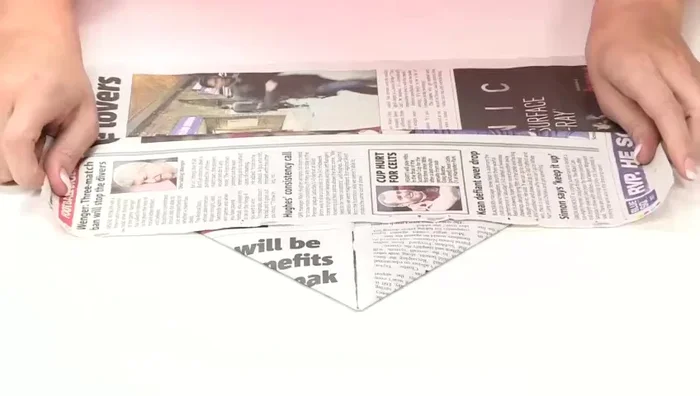 Fold the top piece of paper up again, making a crease across.