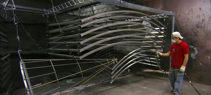 Apply a smooth finish: Spray the welded metal with polyester powder and bake it to create a tough, durable coating.