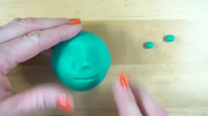 Add details like hair, eyes (using clay or pencil holes).