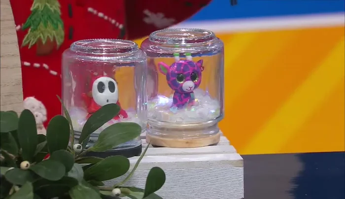 Fill with snow and glitter: Add poly pellets (artificial snow) and glitter to the jar.