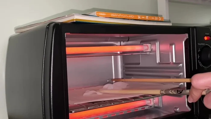 Shrink the Plastic: Use an oven and chopsticks to carefully shrink the plastic, preventing curling.