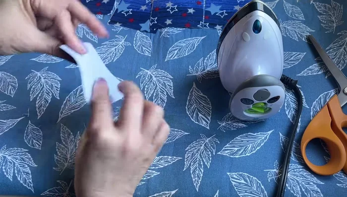 Form the diamond shape: Bring one side of the folded fabric to meet the center, creating a half-diamond shape. Repeat on the other side. Press and iron.