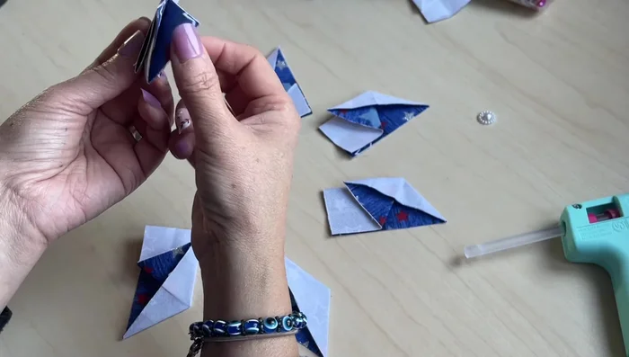 Assemble the star: Arrange the six half-diamonds to form the star shape, applying glue to secure each joint. Make sure each point is aligned correctly to the center before setting the glue.